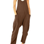 Relaxed fit sleeveless jumpsuit with pockets in neutral tones, styled with sneakers for casual wear.