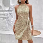 Women’s halter mini dress with polka dot print and wrap waist tie in navy, sage green, khaki, and blush pink.