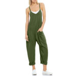 Relaxed fit sleeveless jumpsuit with pockets in neutral tones, styled with sneakers for casual wear.