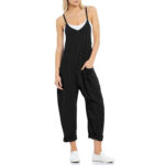 Relaxed fit sleeveless jumpsuit with pockets in neutral tones, styled with sneakers for casual wear.
