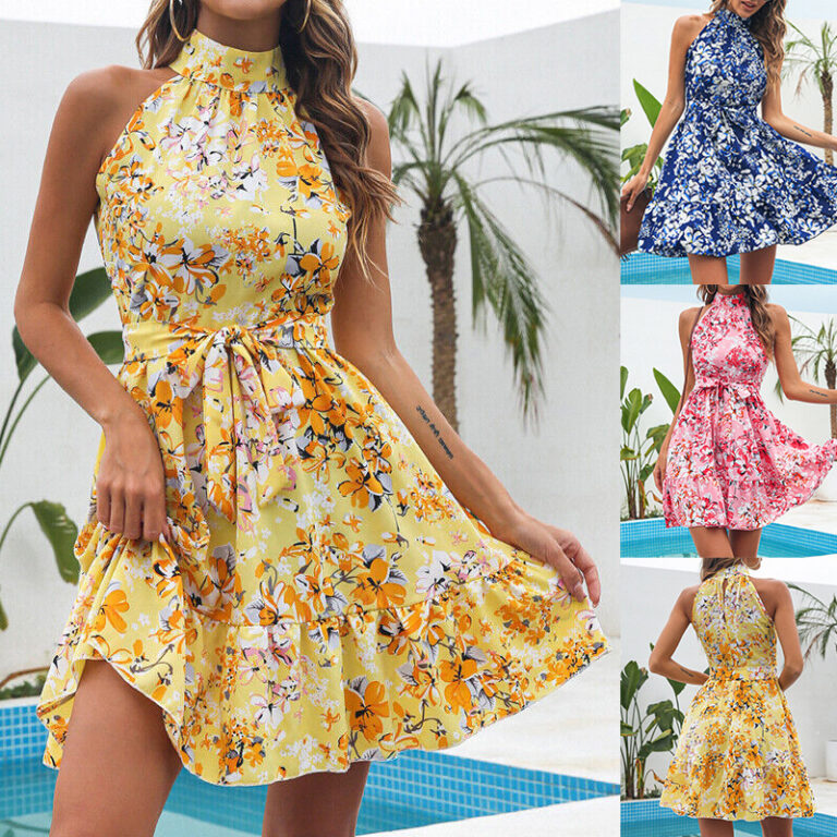 Woman wearing a pink floral halter mini dress with ruffle hem near a poolside setting.