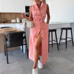 Woman wearing a sleeveless button-front denim maxi dress with a tie waist, utility pockets, front slit styling, and white sneakers, shown in light blue, medium blue, pink, and washed black.