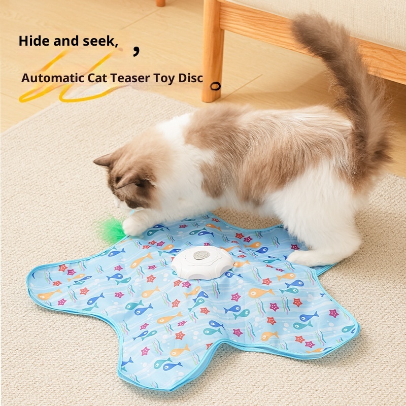 Automatic cat teaser toy disc with blue fish print star-shaped mat, rotating center motor, hidden green feather teaser, and Type-C charging feature.
