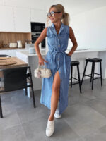 Woman wearing a sleeveless button-front denim maxi dress with a tie waist, utility pockets, front slit styling, and white sneakers, shown in light blue, medium blue, pink, and washed black.
