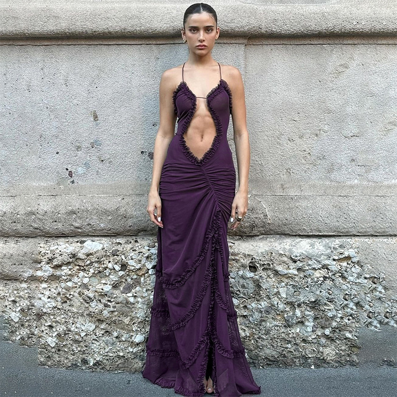 Model wearing a ruffle cutout maxi dress with a plunging front, delicate halter straps, ruched waist, and flowing floor-length skirt.
