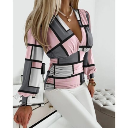 Gray and pink geometric print V-neck long sleeve top with fitted ruched waist.